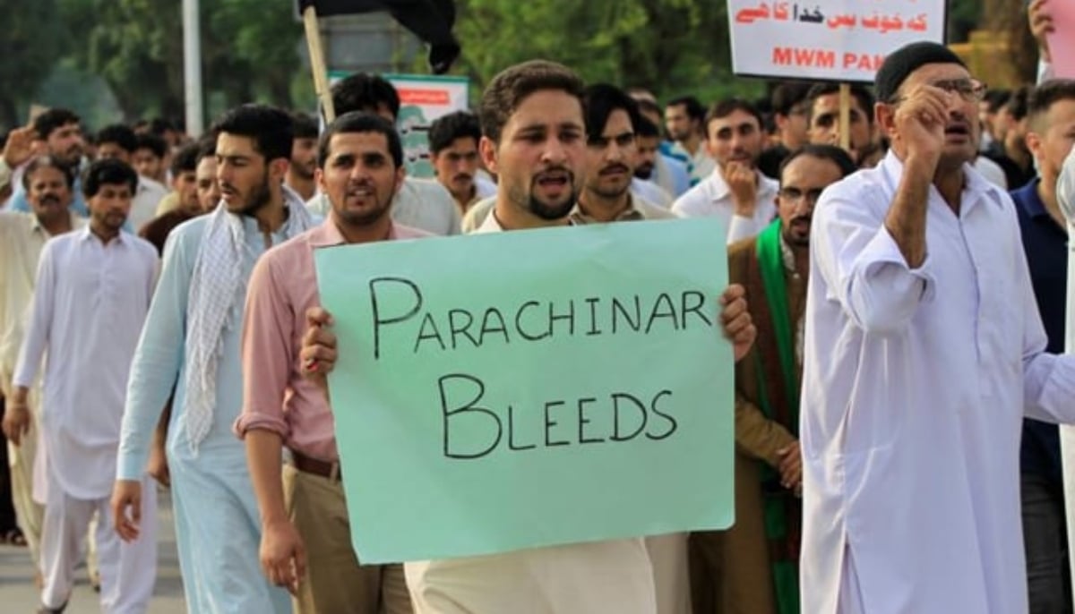 A man holds a placard reading Parachinar Bleeds during a rally. — Reuters/File