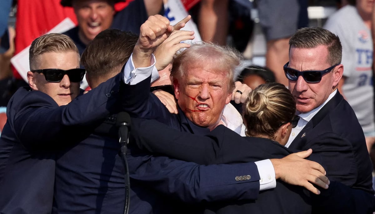 Then Republican presidential candidate Donald Trump is assisted by the Secret Service after gunfire rang out during a campaign rally at the Butler Farm Show in Butler, Pennsylvania, US on July 13, 2024. — Reuters