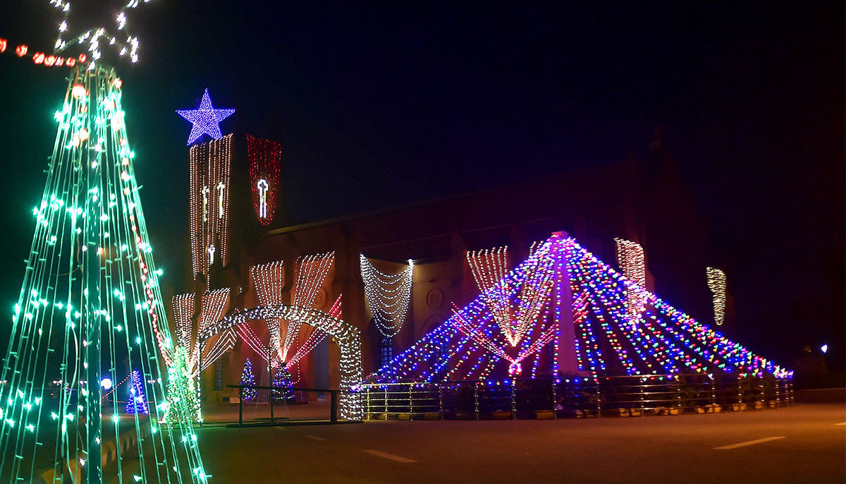 An illuminated view of St. Johns Cathedral Church decorated with colorful lights for Christmas prayer in church during Christmas celebration in Peshawar on December 24, 2024.  — INP