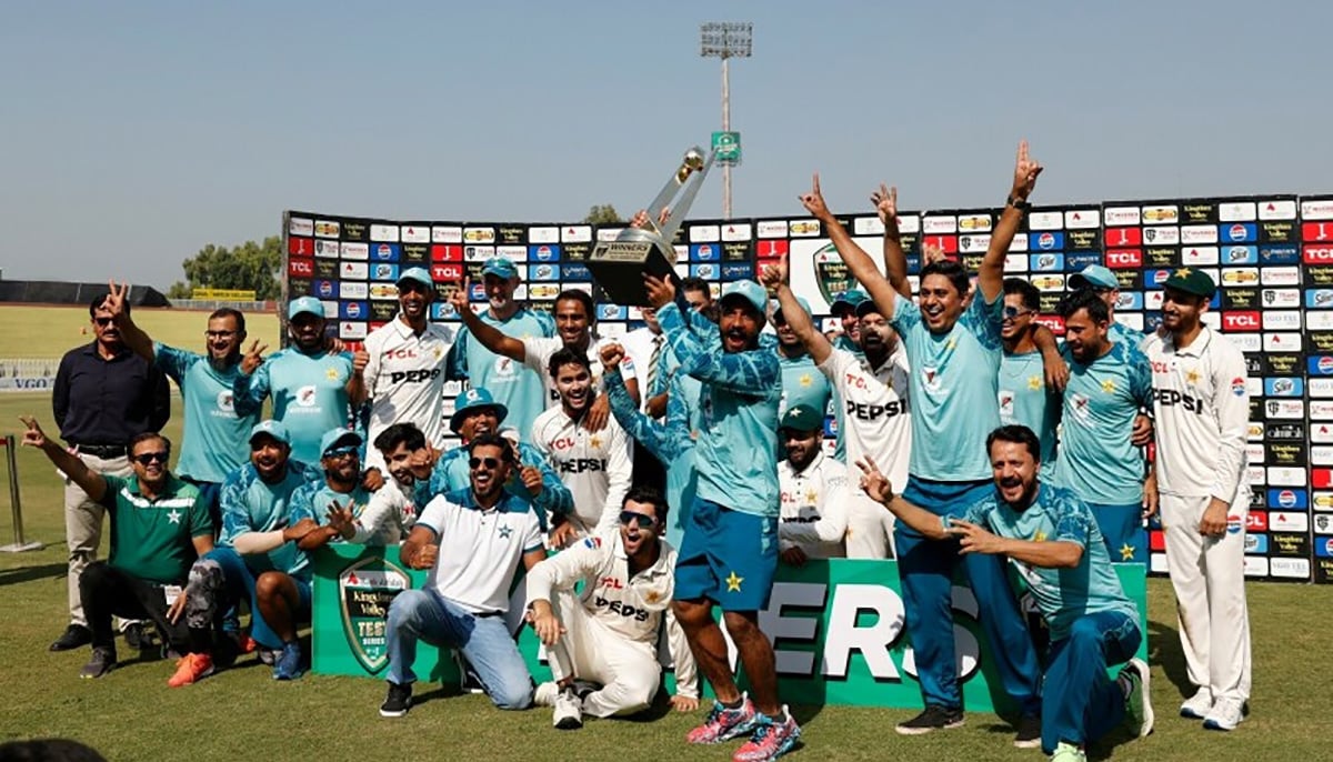 Pakistan players and staff lift the trophy and celebrate after winning the test series against England at Rawalpindi Cricket Stadium on October 26. — Reuters