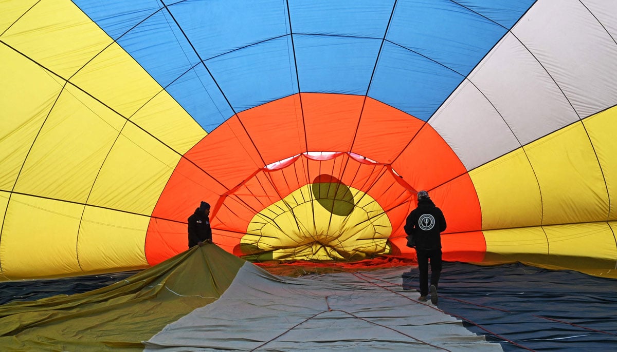 Participants prepare their hot air balloon during the international festival at Pokhara in Nepal on December 25, 2024. — AFP