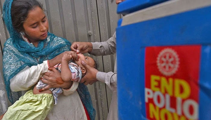 A representational image showing a health worker administering polio vaccine drops to a child. — AFP/File