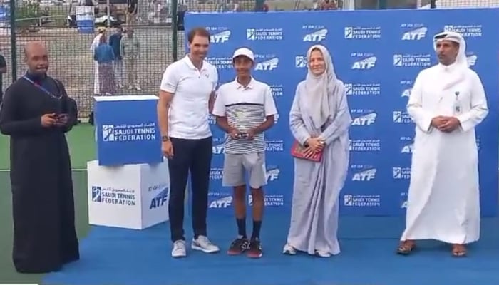 Pakistans Muhammad Hassan Usmani receives trophy from tennis legend Rafael Nadal during the award ceremony of ATF U14 Jeddah. — Reporter