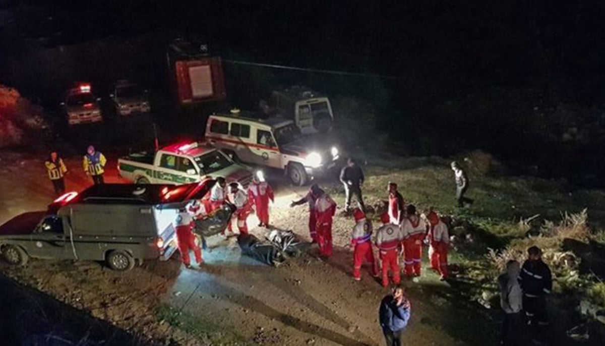 This handout picture provided by the Iranian Mizan News Agency on January 9, 2020 shows Iranian Red Crescent paramedics recovering bodies at the scene of a bus accident that plunged off a mountain road into a ravine in Mazandaran province. — AFP