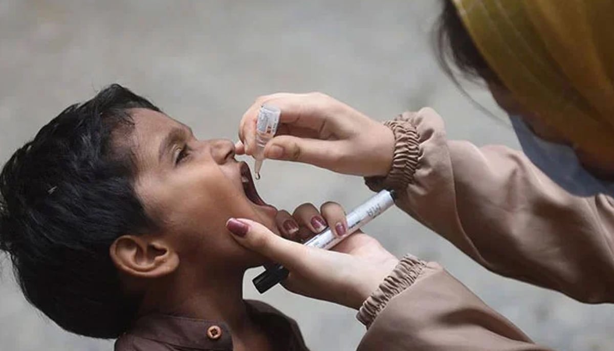 A health worker administers polio drops to a child during a door-to-door vaccination campaign in Karachi on August 7, 2023. — AFP