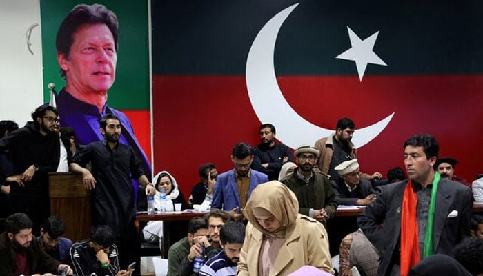 Volunteers for Pakistan Tehreek-e-Insaf (PTI) look on as they watch results on TV screens after the end of the polling during a general election at the partys main office in Islamabad, February 8, 2024. — Reuters