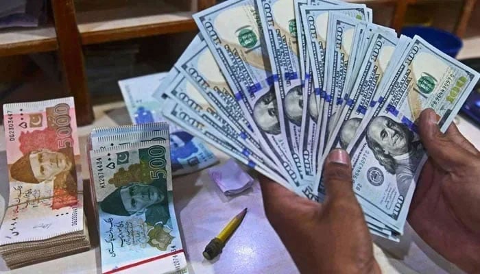 A foreign currency dealer counts US dollars at a shop in Karachi, on May 19, 2022. — AFP/File