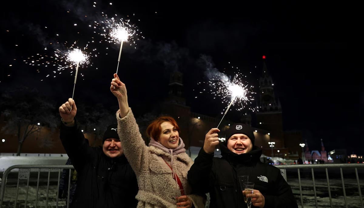 People light sparklers during New Year celebrations near Red Square in central Moscow, Russia, January 1. — Reuters