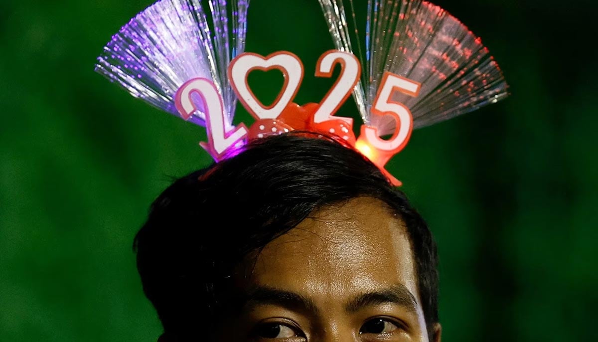 A man wearing a 2025 headband attends New Years Eve celebrations in Jakarta, Indonesia, December 31. — Reuters