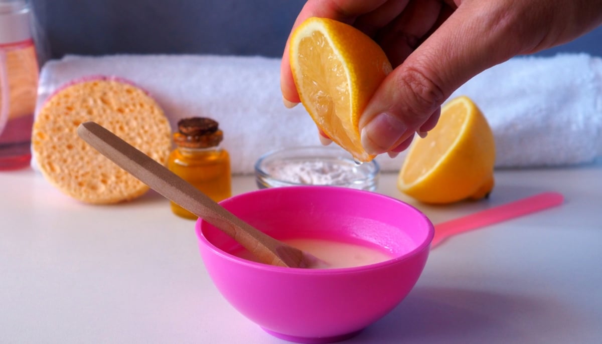 A representational image of a lemon being squeezed into a mixture for skincare. — Canva