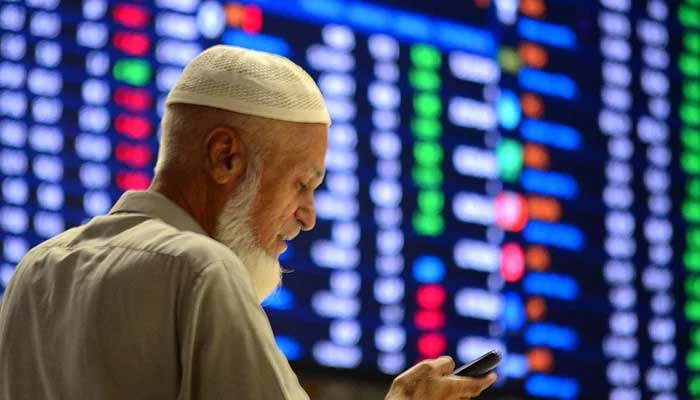 A Pakistani stockbroker monitors share prices during a trading session at the PSX in Karachi, on October 17, 2024. — INP