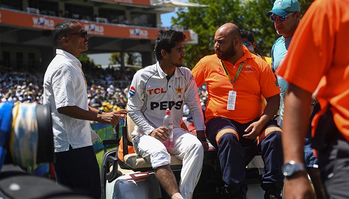 Pakistans Saim Ayub (2nd L) is assisted off the field after being injured during the first day of the second international Test cricket match between South Africa and Pakistan at Newlands stadium in Cape Town on January 3, 2025. — AFP