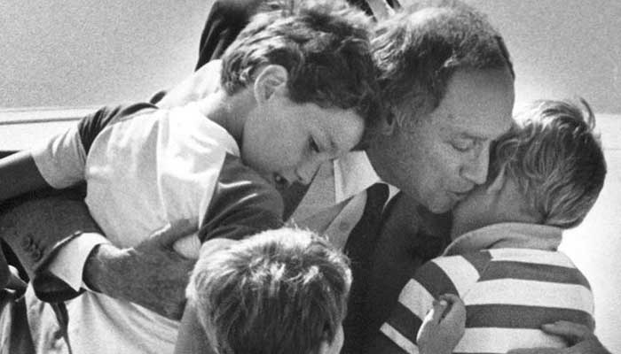 Canadas Prime Minister Pierre Trudeau greets his sons Justin (left), Sacha (right) and Michel after returning home from a foreign trip in Ottawa, Canada, 1983. — Reuters